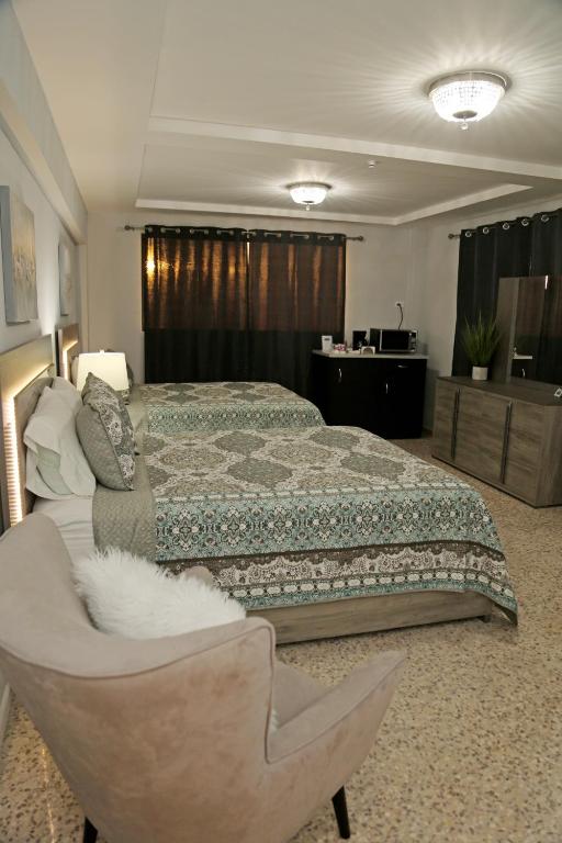 Postel nebo postele na pokoji v ubytování Itza-Bella Suites