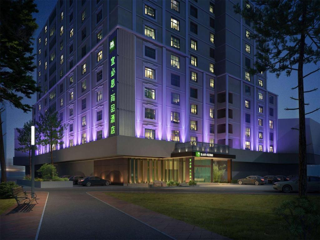 a building with purple lights on the side of it at Ibis Styles XM Zhongshan Hotel in Xiamen