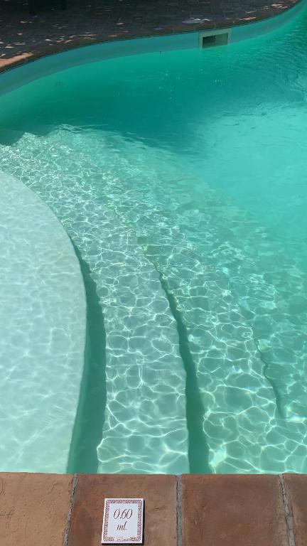 una piscina con un cartel en el agua en Azienda Agrituristica I Tre Casali en Magione
