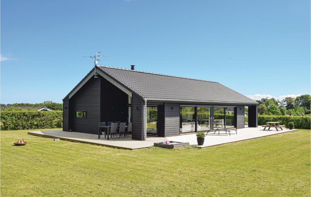 a small black cabin with a picnic table in a field at Stunning Home In Humble With Kitchen in Humble