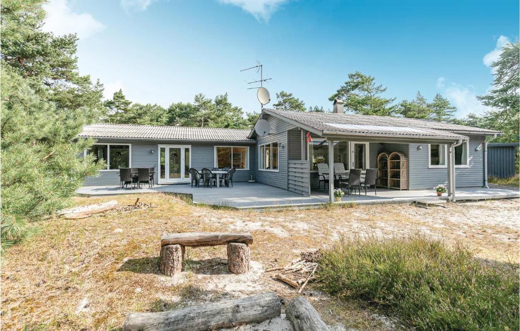a small blue house with a patio in front of it at Holiday Home I Klitterne Nexø I in Spidsegård