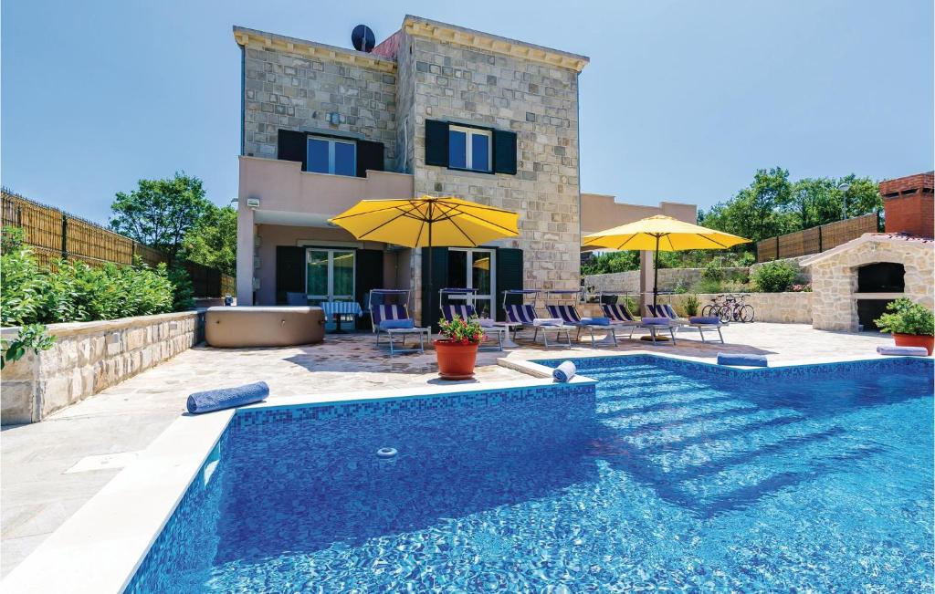 a villa with a swimming pool and a house at Stunning Home In Zaton With Jacuzzi in Zaton