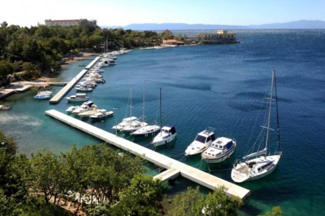 a group of boats docked at a dock in the water at Argola Kraljevica apartment in Kraljevica