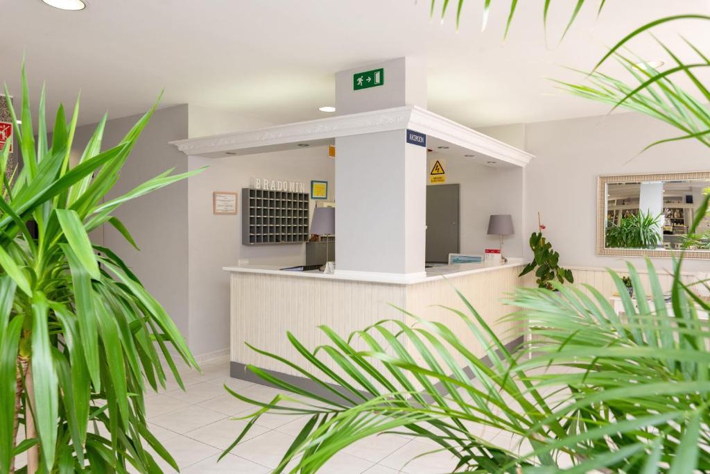 a gas station with plants in the foreground at Hotel Bradomin in Villanueva de Arosa