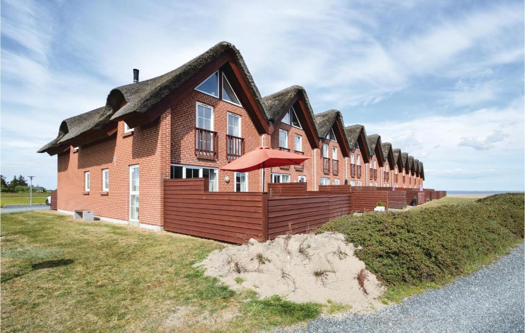 a large house with a thatched roof at Amazing Home In Rm With House Sea View in Bolilmark