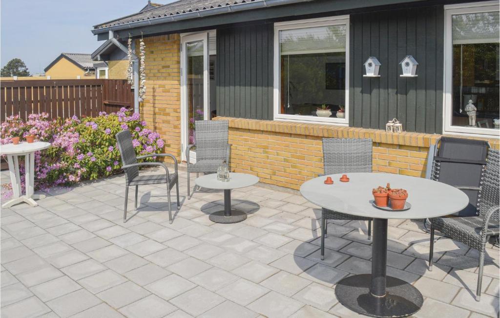 a patio with two tables and chairs on it at 1 Bedroom Lovely Home In Skagen in Skagen
