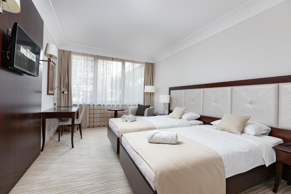 Postel nebo postele na pokoji v ubytování GARNI HOTEL AMI