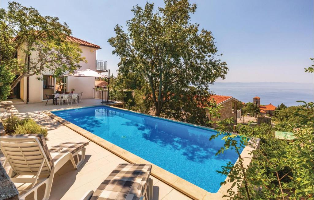 a swimming pool in the backyard of a house at Cozy Home In Gornji Tucepi With Wifi in Tučepi