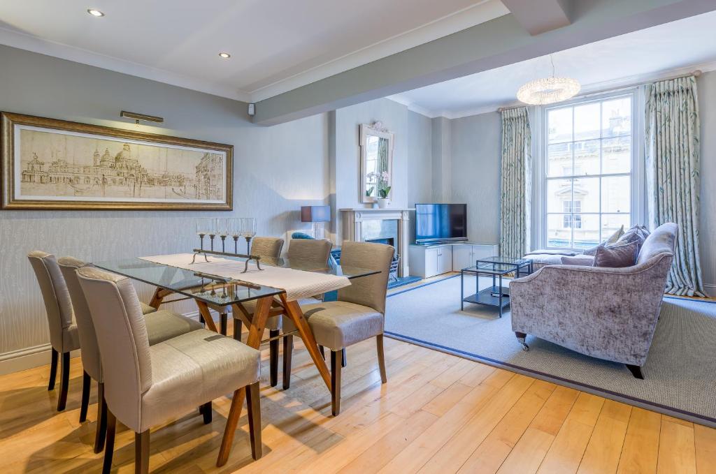a living room with a dining table and chairs at Luxury Apartments - 10 Royal Parade in Cheltenham
