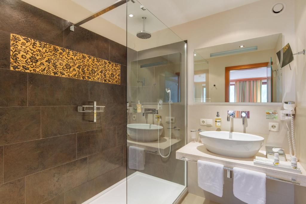 a bathroom with a sink and a shower at Berg-Spa & Hotel Zamangspitze in Sankt Gallenkirch