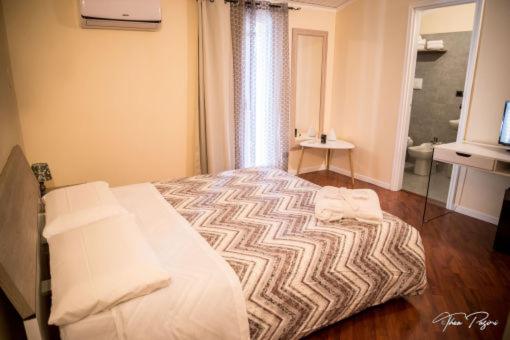 Postel nebo postele na pokoji v ubytování Hotel Lonatino