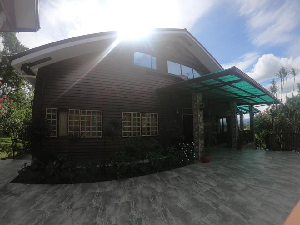 a house with the sun shining on top of it at Villa del Carmen Haven Bohol in Carmen