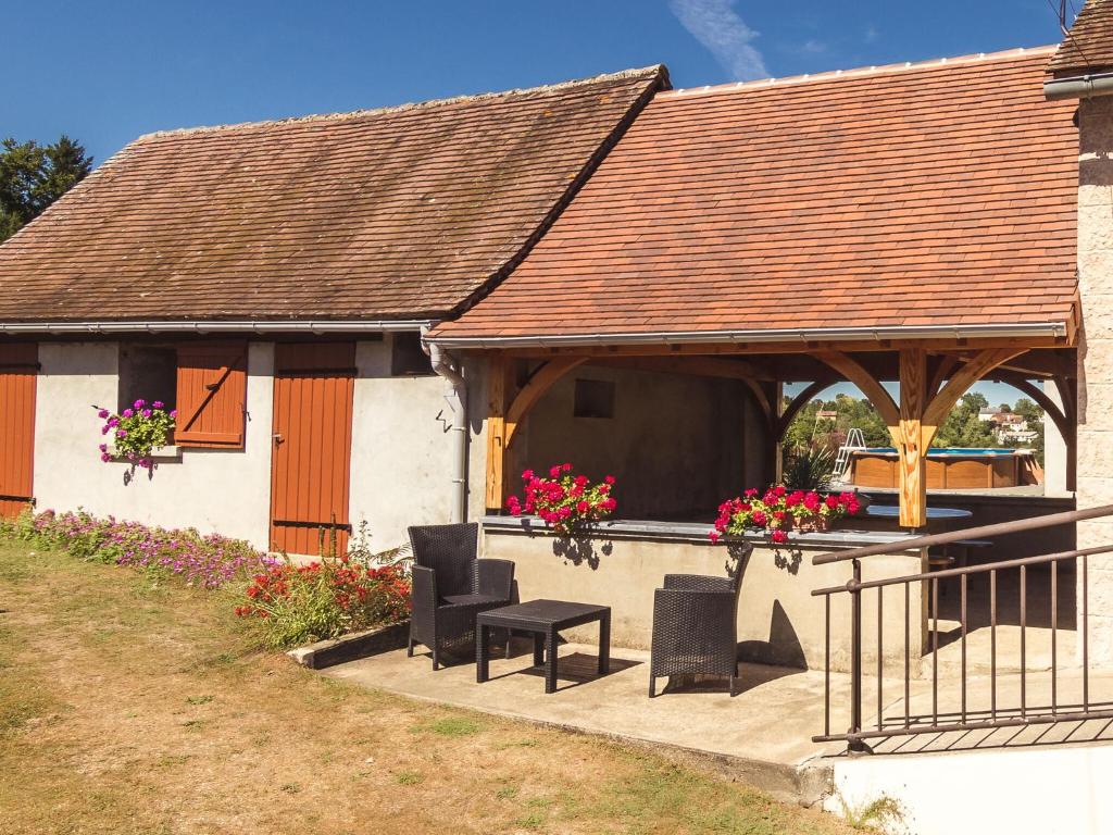 a house with a gazebo with a table and chairs at Beautiful holiday home near lake and forest in Payzac