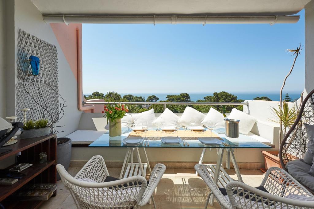 a room with a table and chairs and a balcony at Luxury Sea View in Cascais