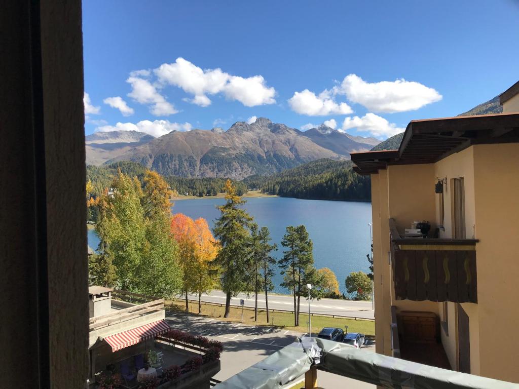 a view of a lake from a balcony at Chesa Sonnalpine B 33 in St. Moritz