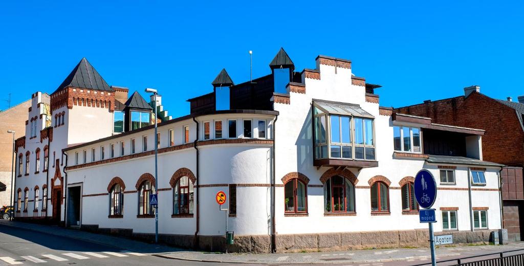 ein großes weißes Gebäude an der Ecke einer Straße in der Unterkunft City HotelApartment in Karlshamn