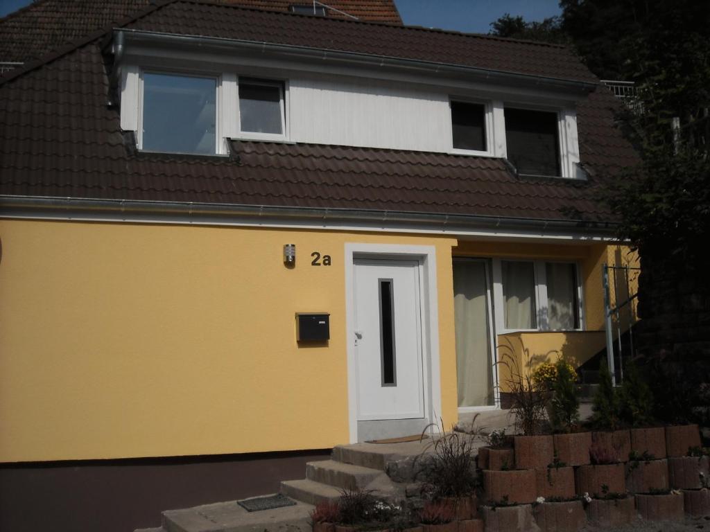 a yellow and white house with a white door at Hermann's Neue Post in Calw