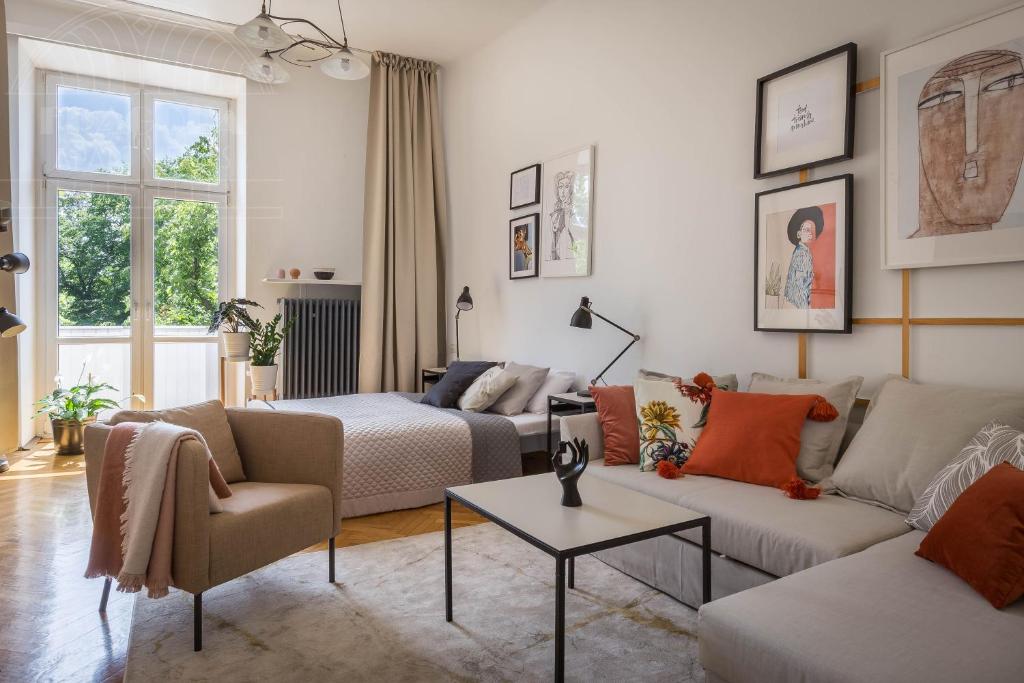 a living room with two couches and a table at Cozy Old Town Apartments in Kraków