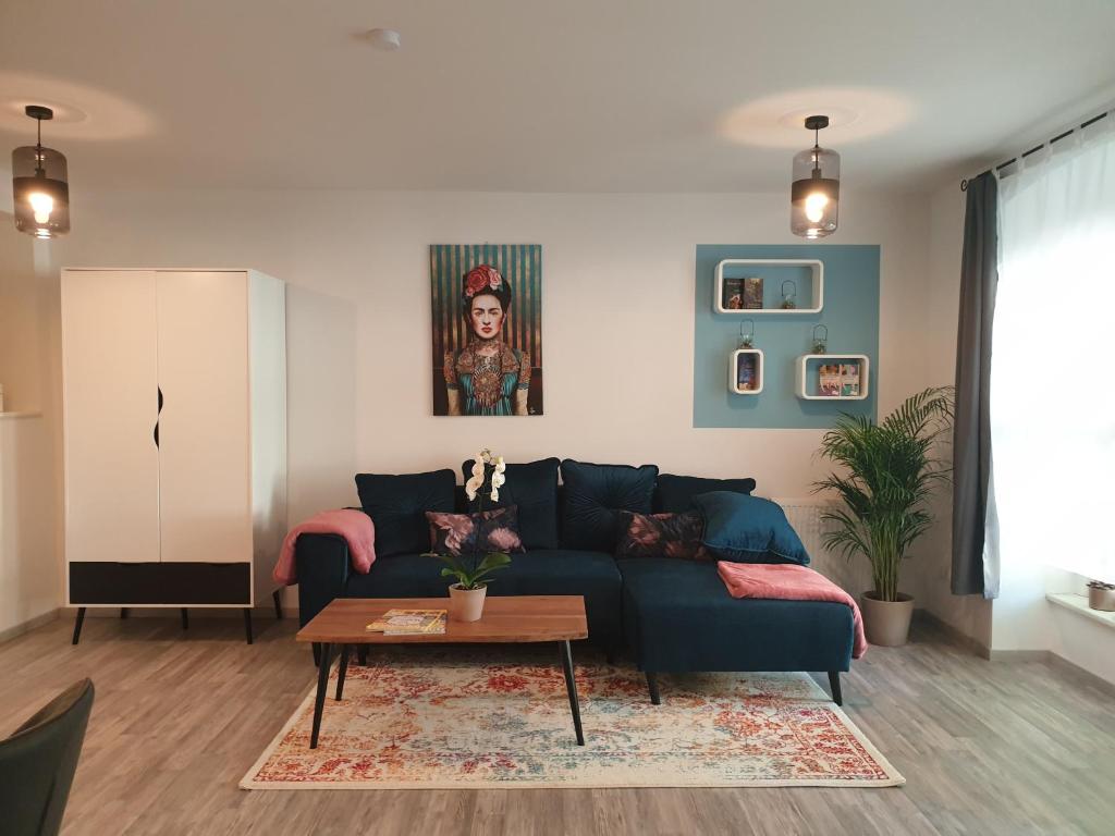 a living room with a blue couch and a table at Studioapartment L46 - in exklusiver Innenstadtlage in Potsdam