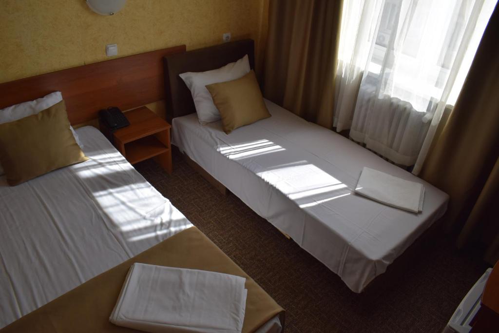 Postel nebo postele na pokoji v ubytování Slavyanska Beseda Hotel