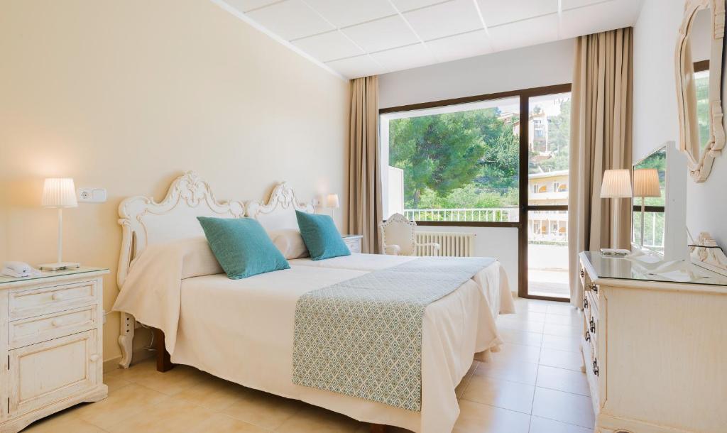 Postel nebo postele na pokoji v ubytování Hotel Gaya
