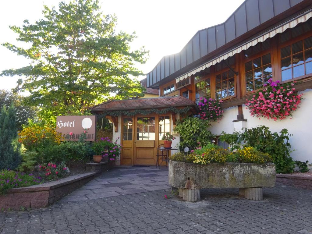 a building with flowers in front of it at Hotel Altenberg in Baden-Baden