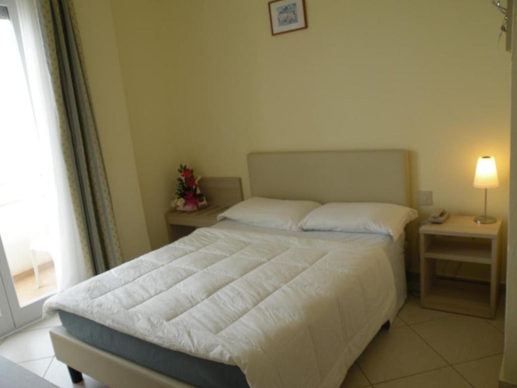 Postel nebo postele na pokoji v ubytování Hotel Parrini