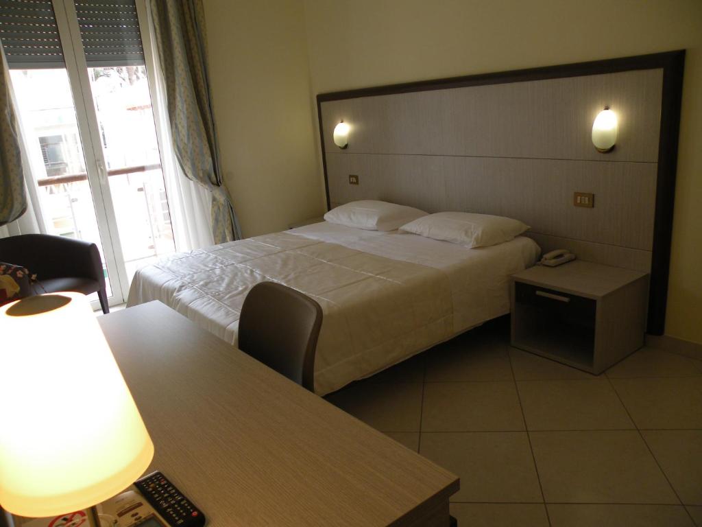 Postel nebo postele na pokoji v ubytování Hotel Parrini
