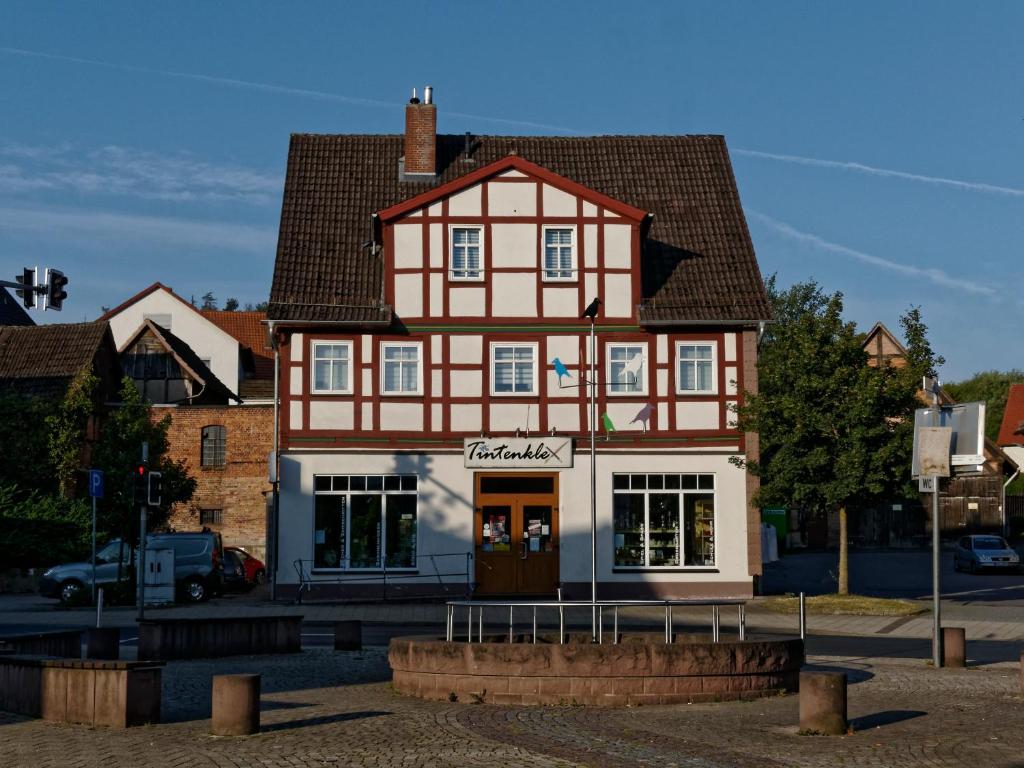 a red and white building with a store at Haus Tintenklex in Eschershausen