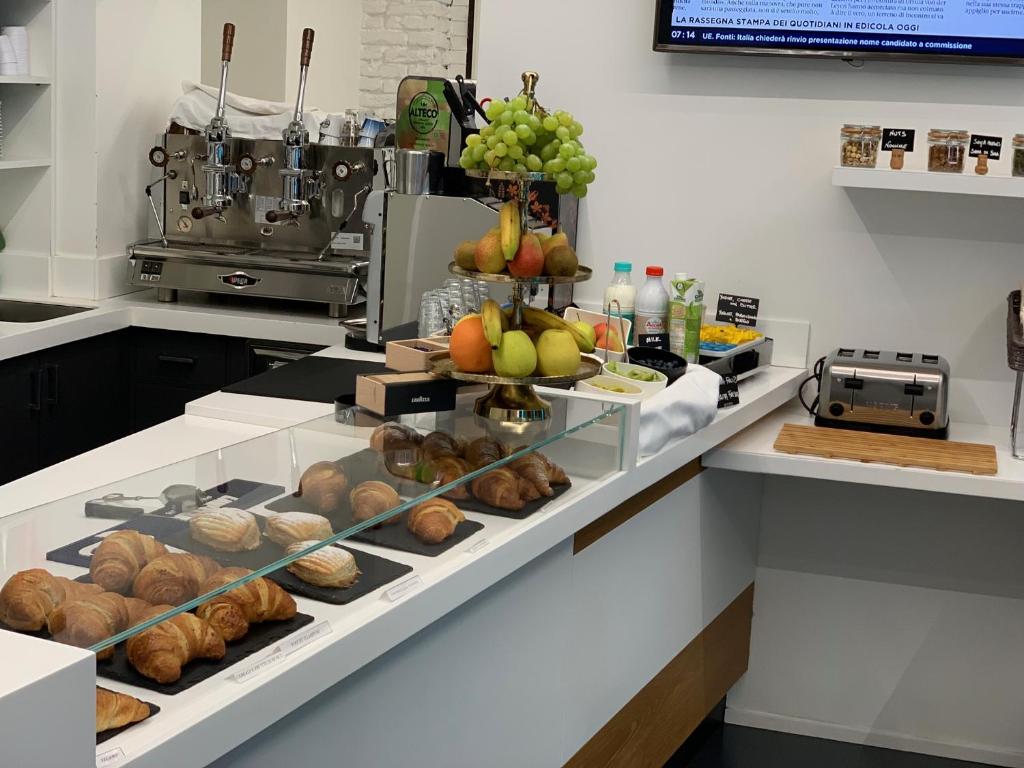 a kitchen with a bunch of bread and fruit on display at Adalesia Hotel & Coffee in Turin