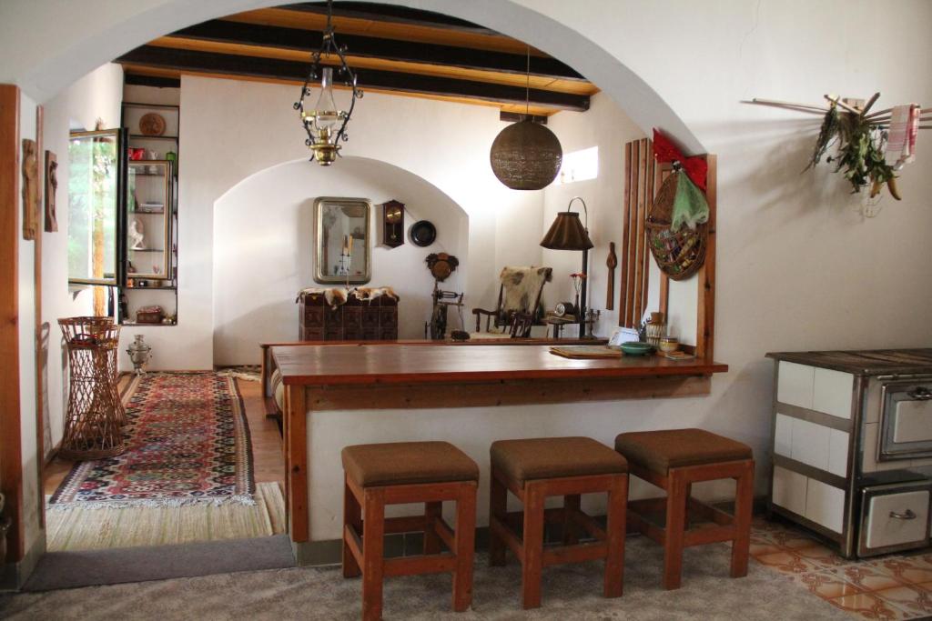 a kitchen with a table and stools in a room at Country house Horné Držkovce in Horné Držkovce