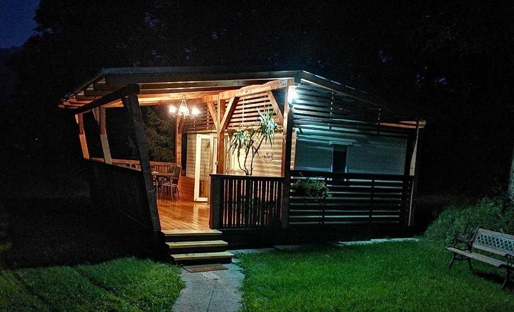 a small cabin with a deck at night at Samson mobile house in Bled