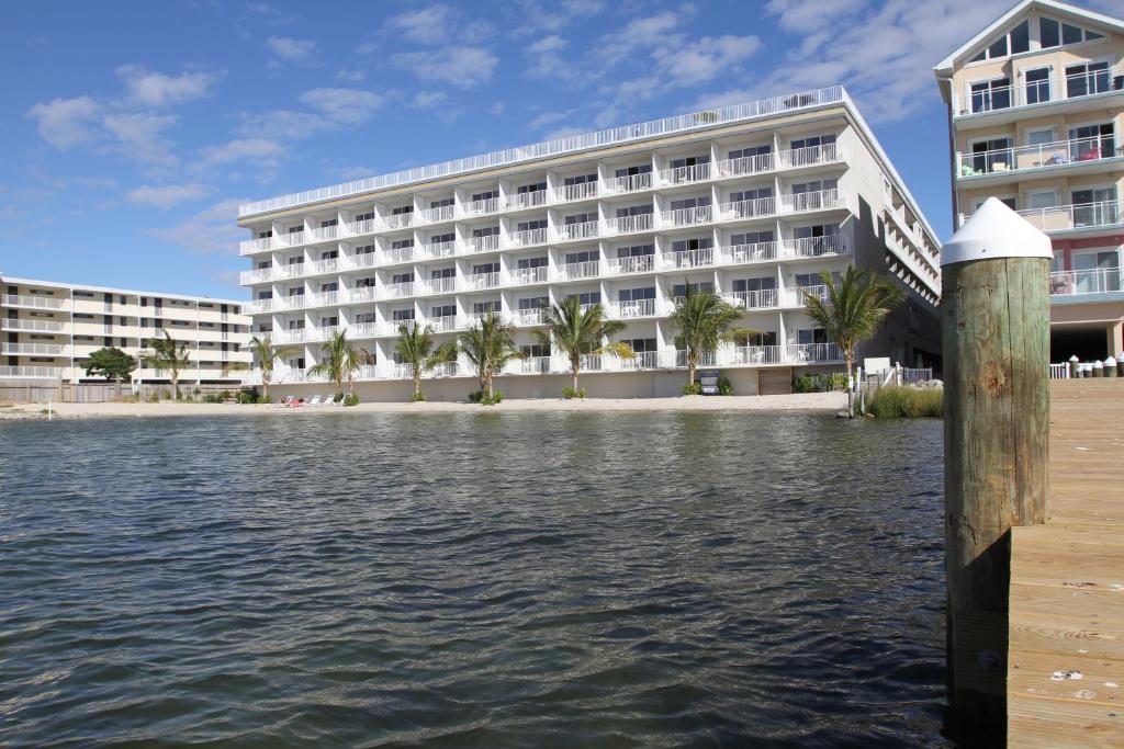 a hotel with a dock in front of a body of water at Princess Bayside Beach Hotel in Ocean City