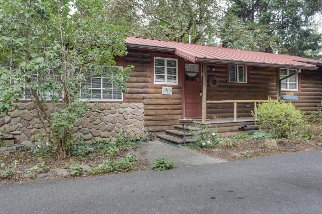 a small log cabin with a red roof at Molalla River Cottage in Molalla
