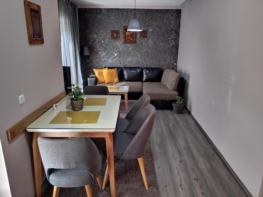 a living room with a table and chairs and a couch at Apartment LAVO Center in Ohrid