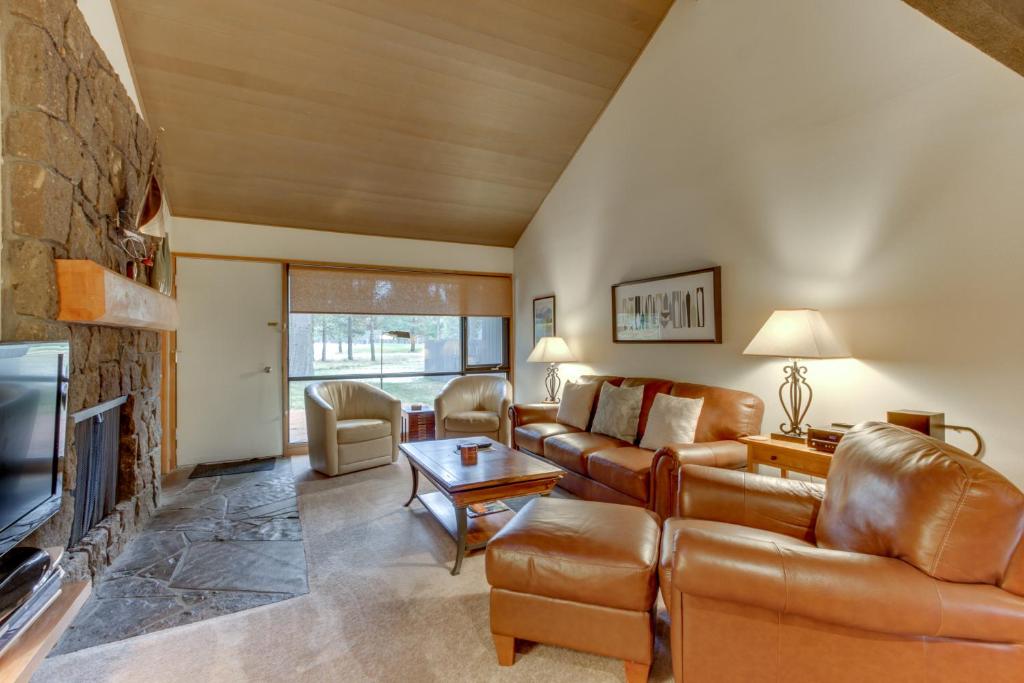 a living room with a couch and a fireplace at Meadow House 76 | Discover Sunriver in Sunriver