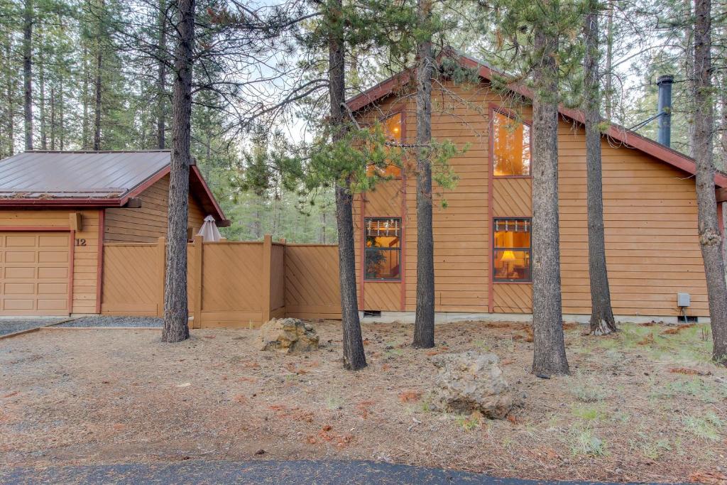 a house in the woods with a garage at Otter Lane 12 | Discover Sunriver in Sunriver