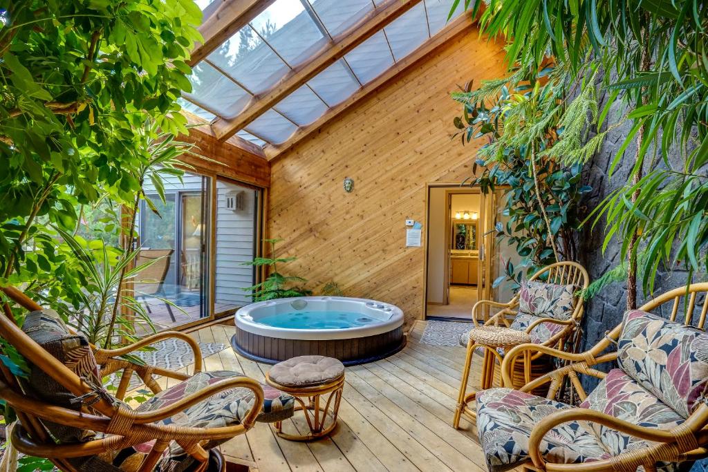 a patio with a hot tub in a room with plants at Poplar 12 | Discover Sunriver in Sunriver