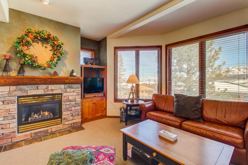 a living room with a couch and a fireplace at Eagle Run 107 in Mammoth Lakes