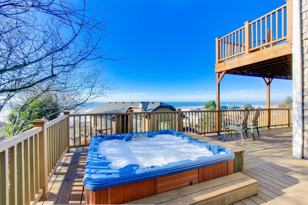 a hot tub on the deck of a house at Annie's Windsong in Lincoln City