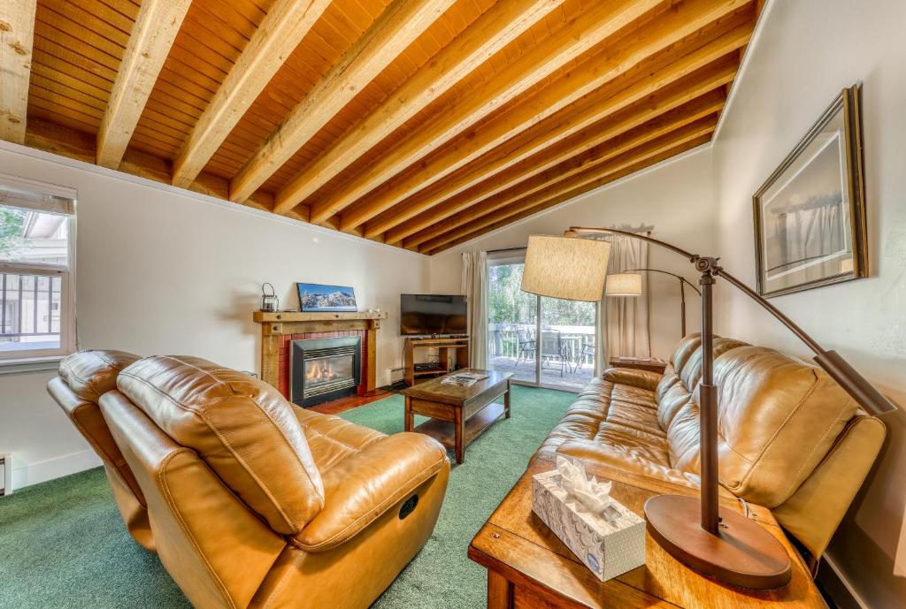 a living room with leather furniture and a fireplace at Single Level Ranch Condo in Elkhorn in Sun Valley