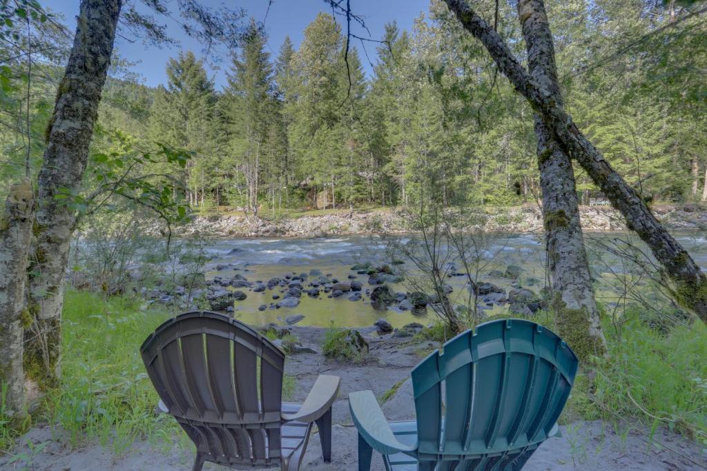 two chairs sitting in front of a river at Stone's Throw in Welches