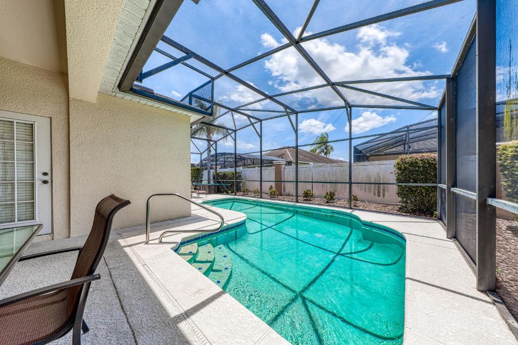a swimming pool in a house with a glass ceiling at Windstar Villa in Davenport