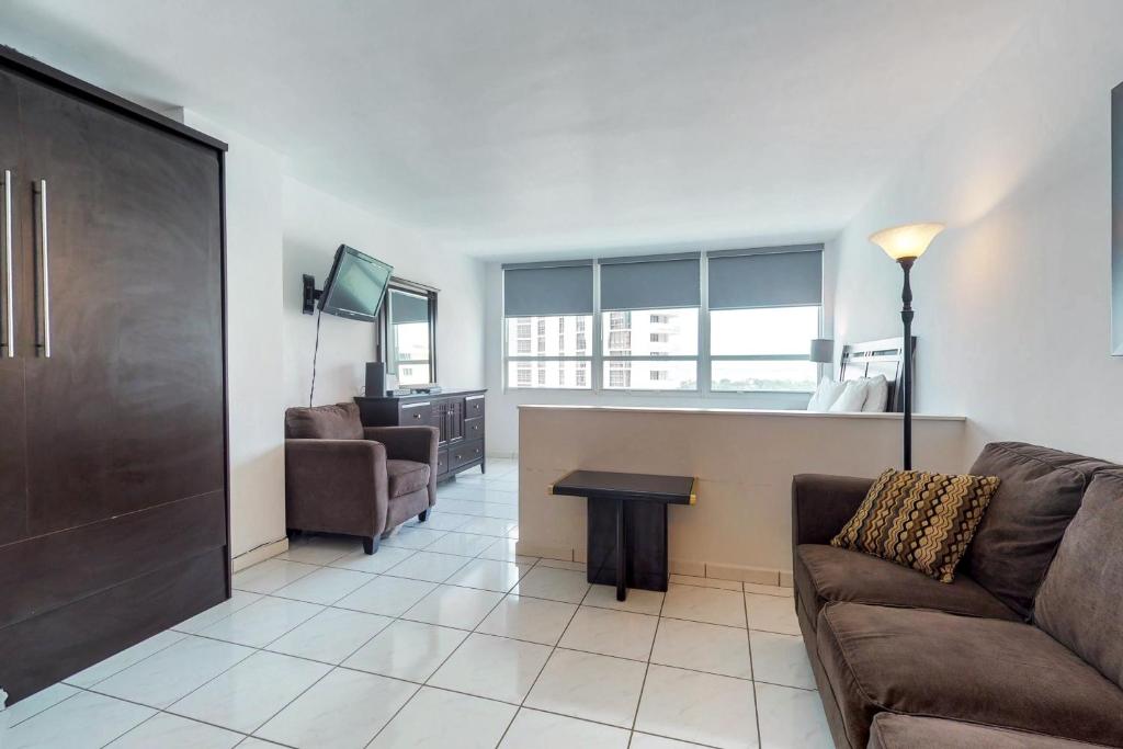 a living room with a couch and a table at Castle Beach: Serenity Condo in Miami Beach