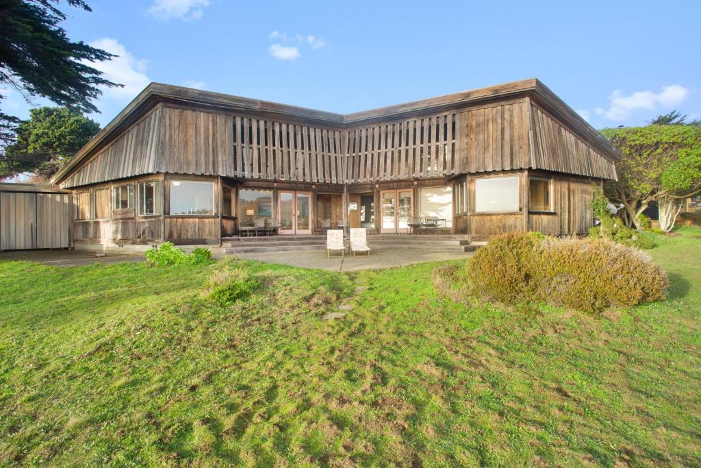 a large wooden house with a lawn in front of it at Curtis-Moulton Retreat in Sea Ranch