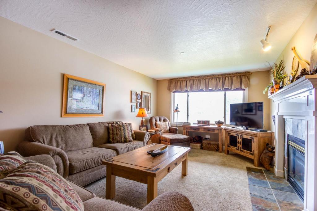 a living room with a couch and a tv at Lazy on the Lakefront (F205) in Twin Beaches