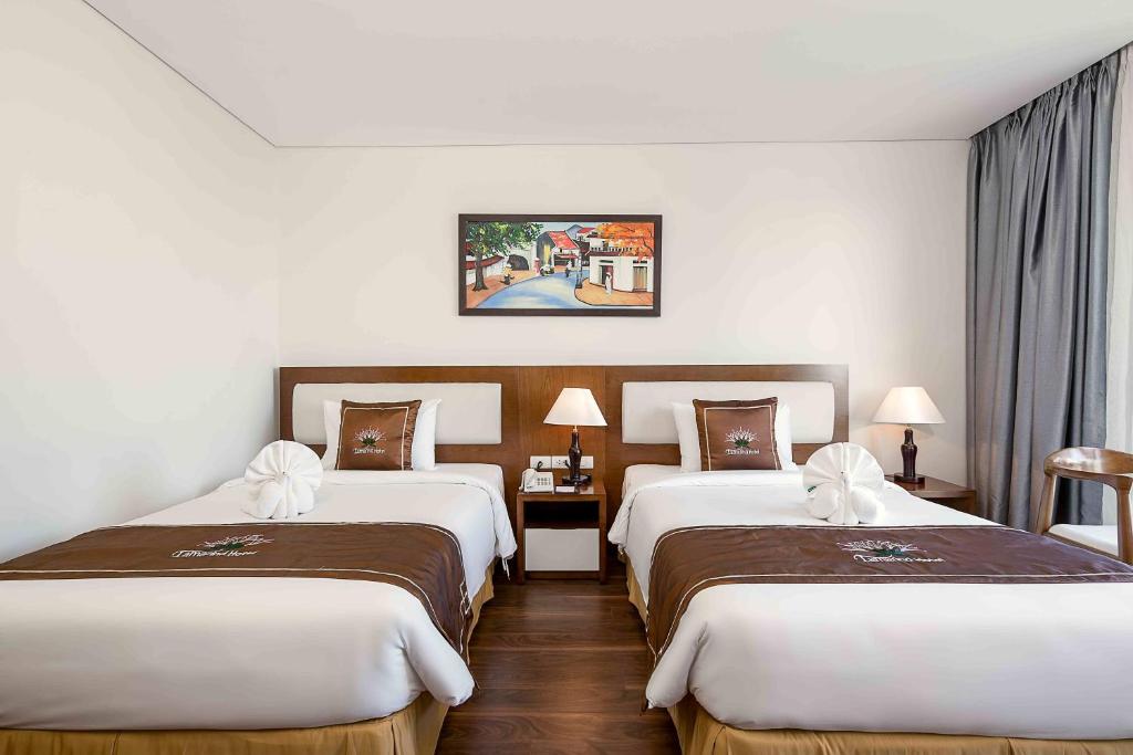 Voodi või voodid majutusasutuse Tamarind Danang Beach Hotel toas