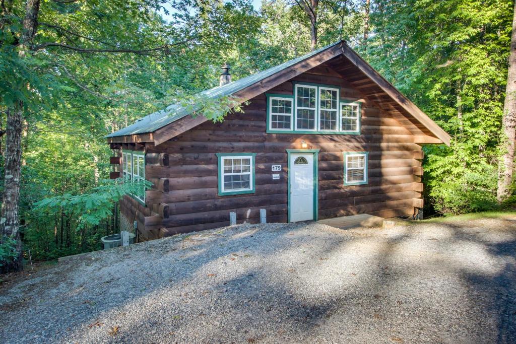 a log cabin with a door in the woods at Idlewild in Sautee Nacoochee