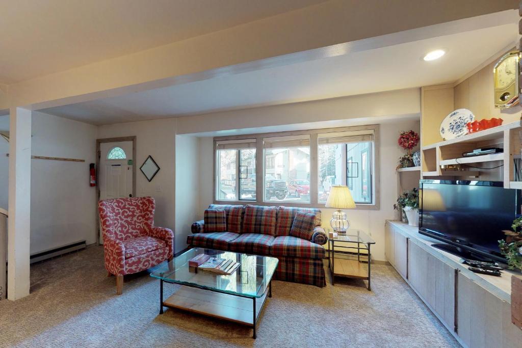 a living room with a couch and a tv at Prospector Condo in Ketchum