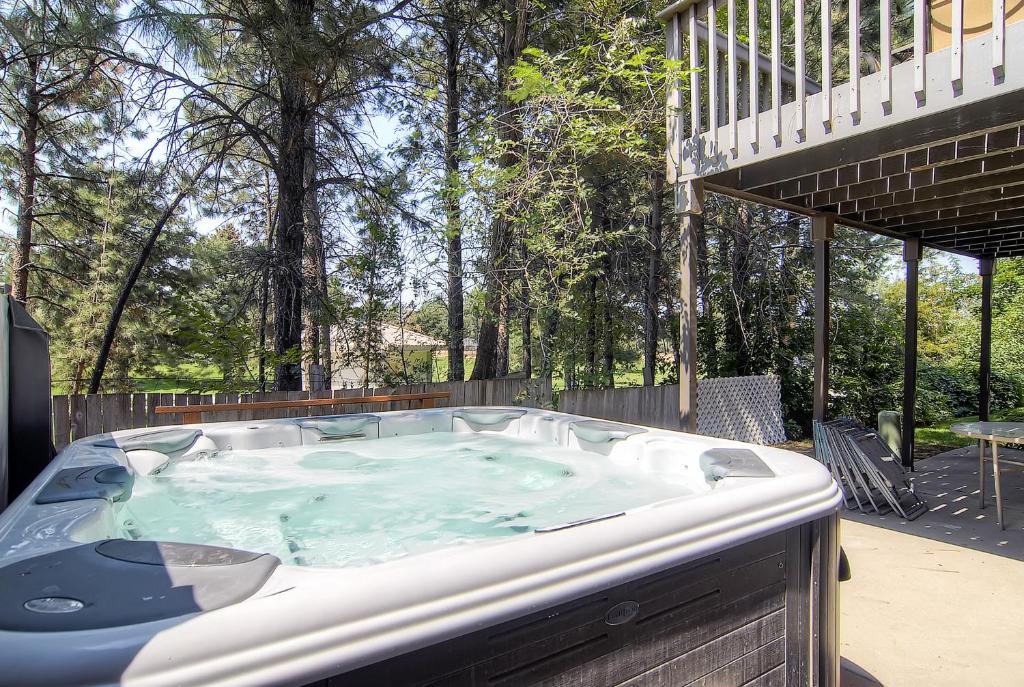 a jacuzzi tub in a backyard with a deck at Oaks at Wasatch #7 in Cottonwood Heights